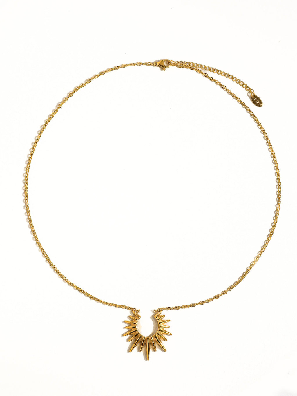 Small chain necklace with a sun pendant on a white background.