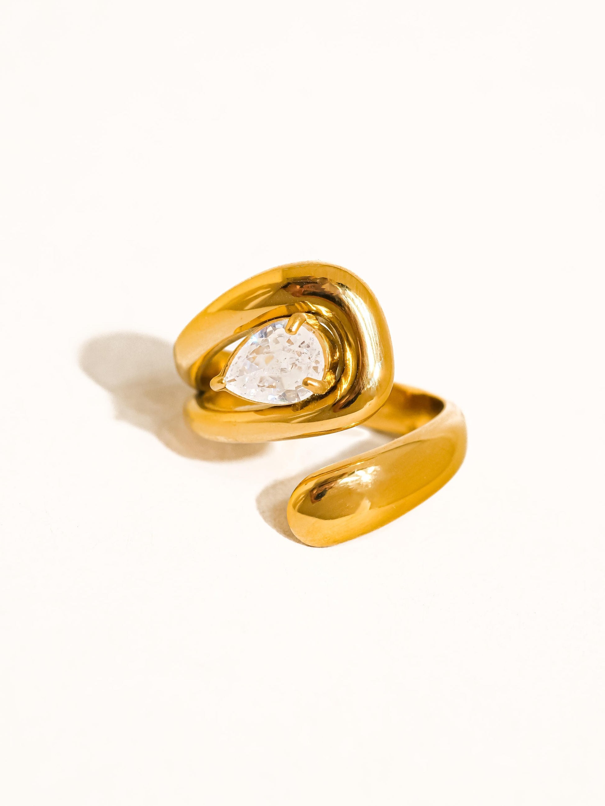 Gold ring with a diamond on a white background