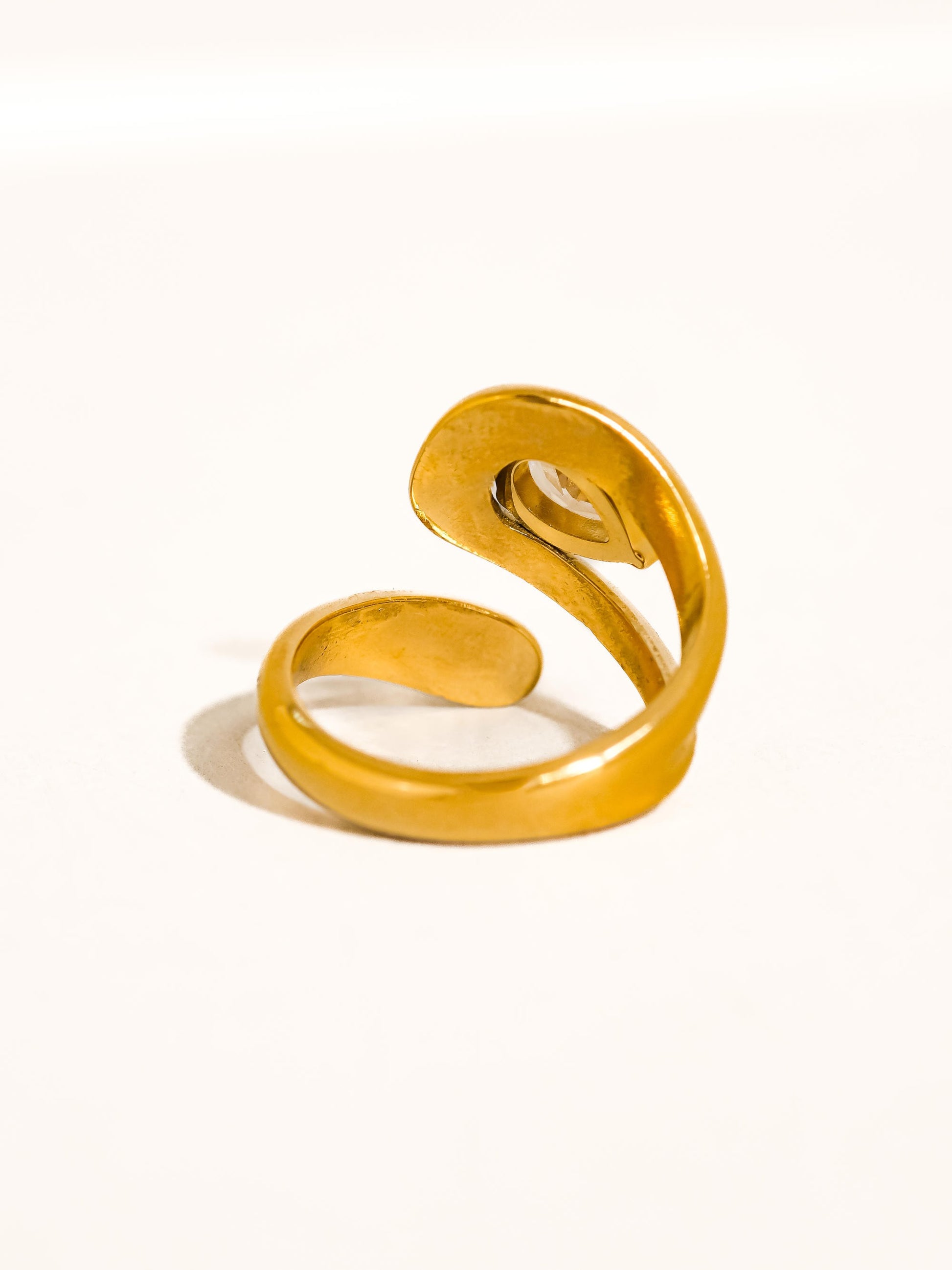 Gold spiral ring on a white background