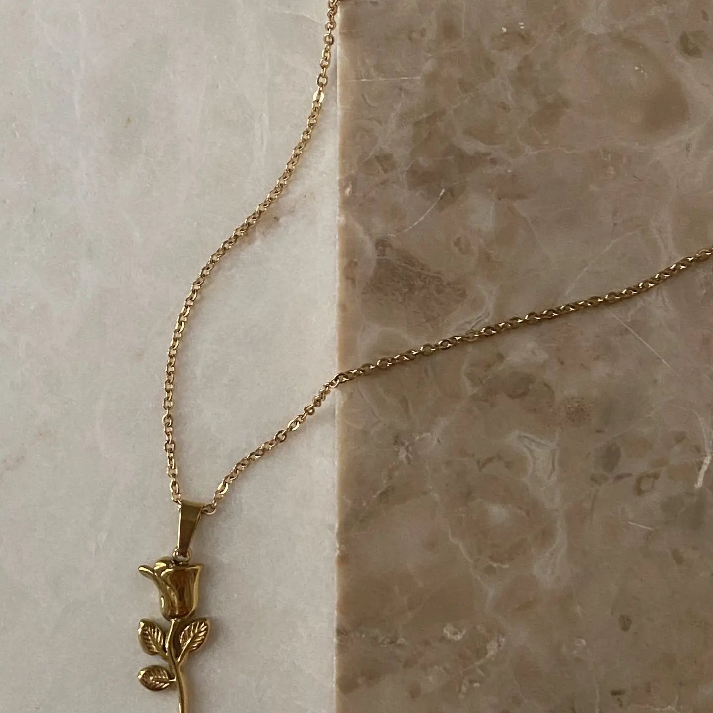 Rose Pendant Necklace on granite Background